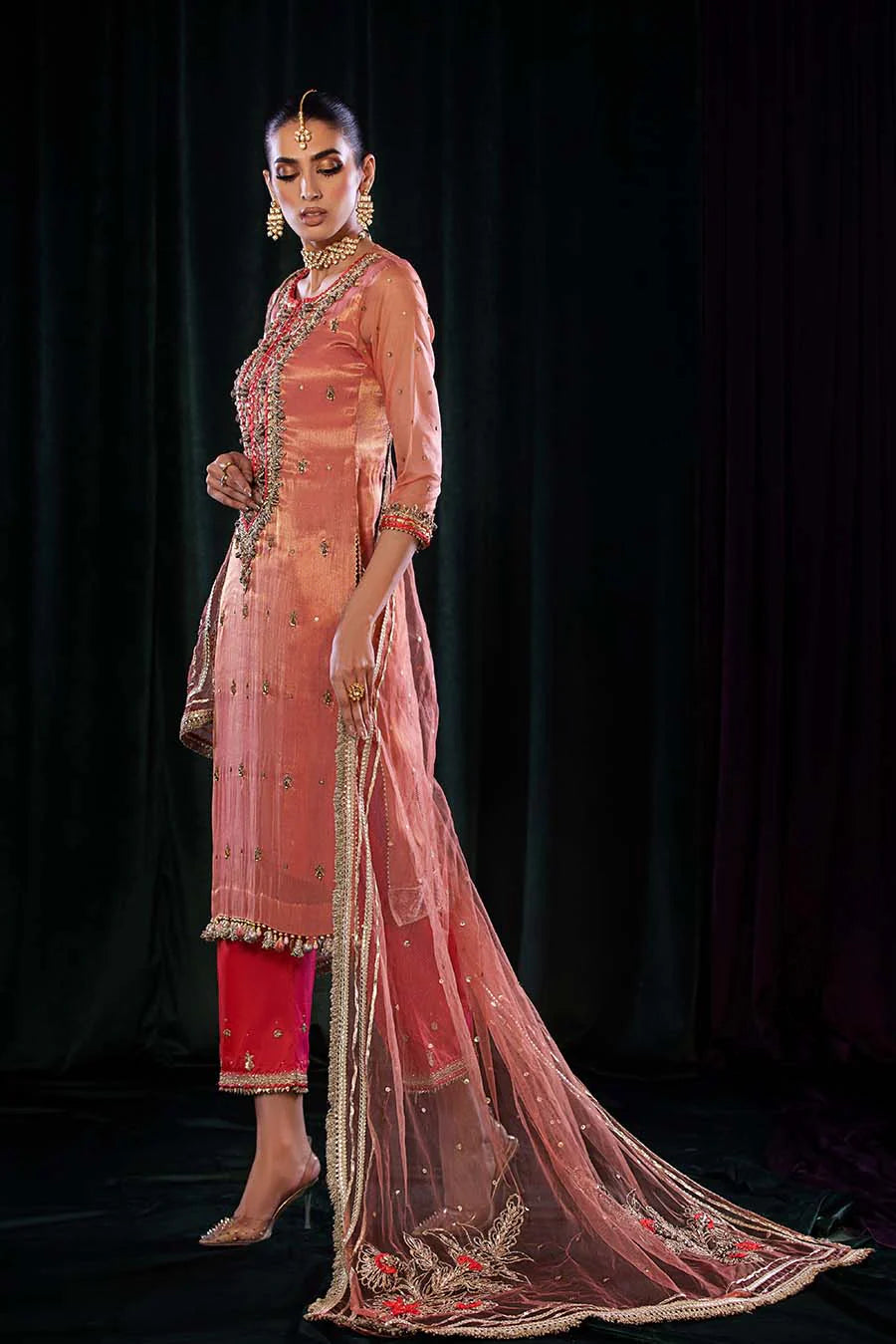 Model draped in hand-embellished outfit, showing all pieces