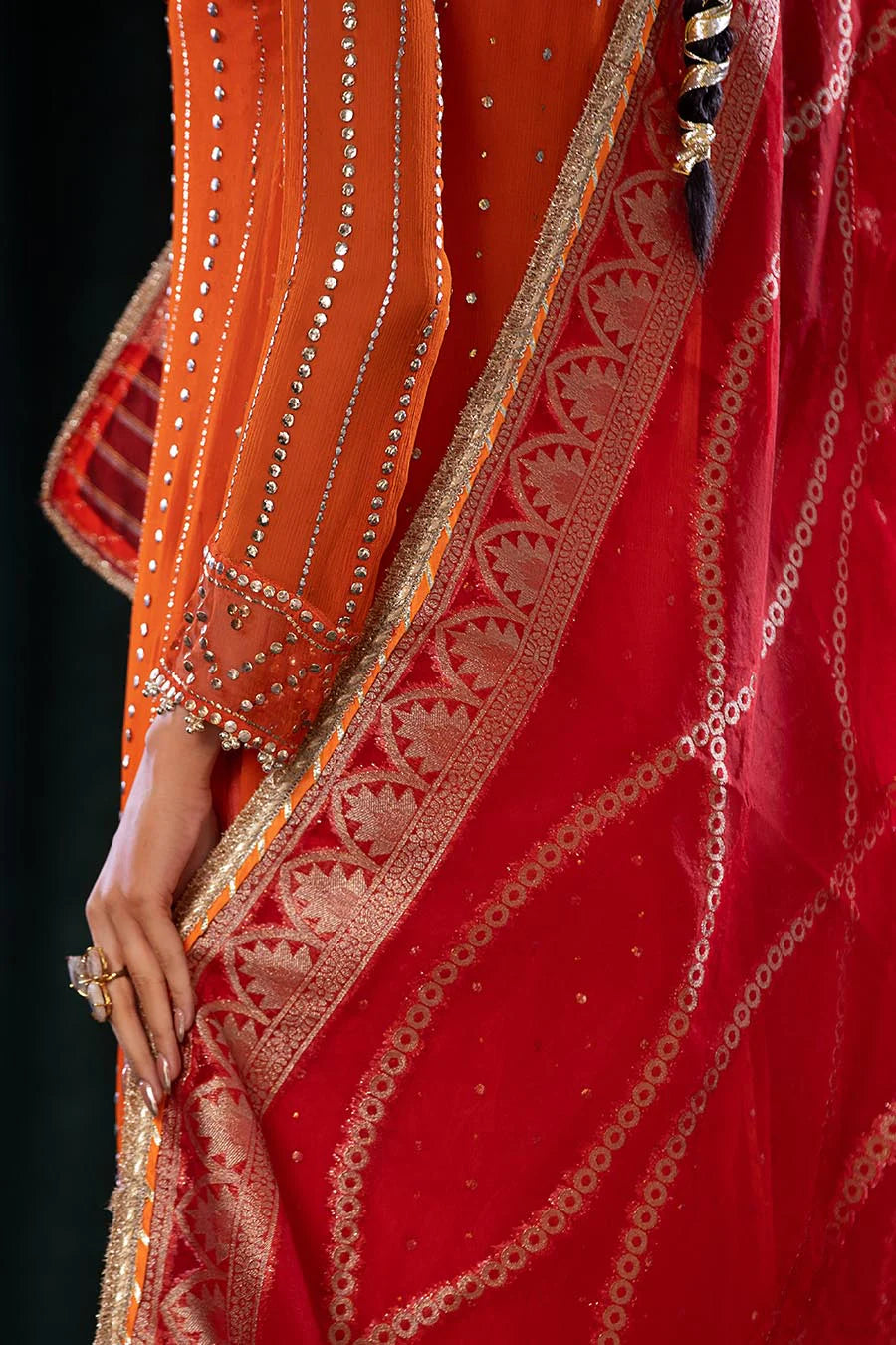 Intricate embroidery on front and sleeves of shirt