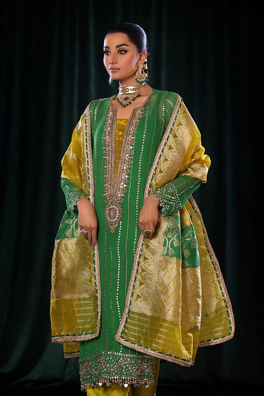 Model wearing outfit with dupatta flowing over arm