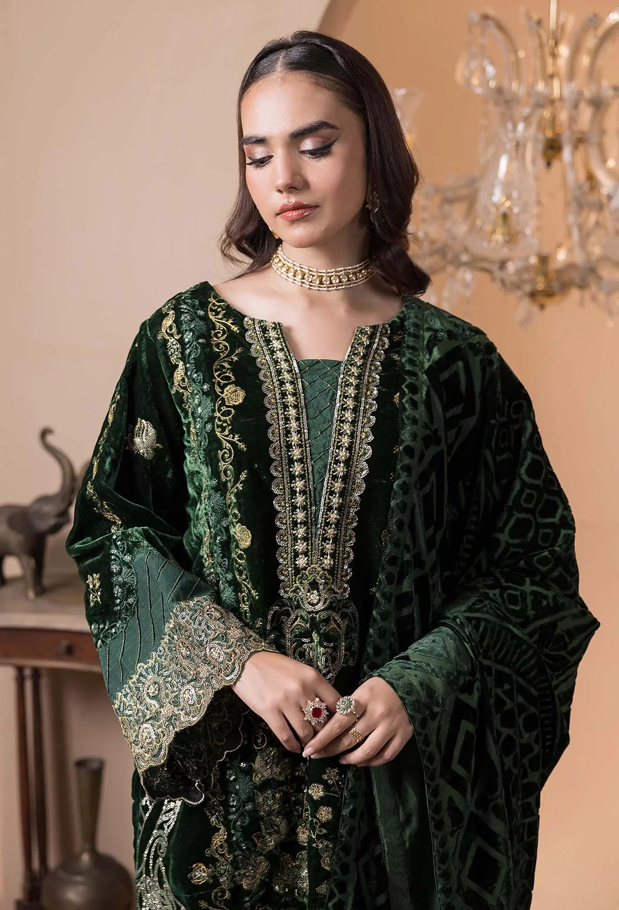 Elegant green velvet kameez with raw silk trousers and velvet shawl