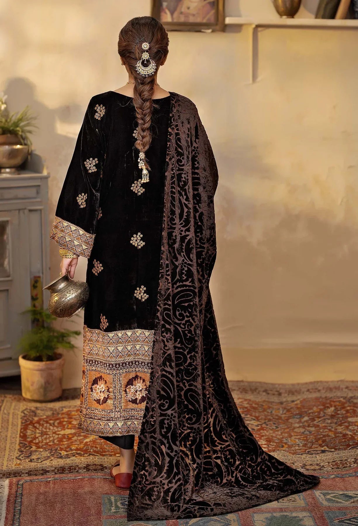 Stand out with this black velvet salwar kameez featuring vibrant orange embroidery, complete with a luxurious velvet shawl. Available at Mahaba Studio USA.