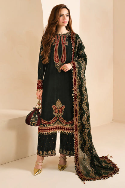 Elegant green velvet Pakistani salwar kameez with intricate embroidery on the front