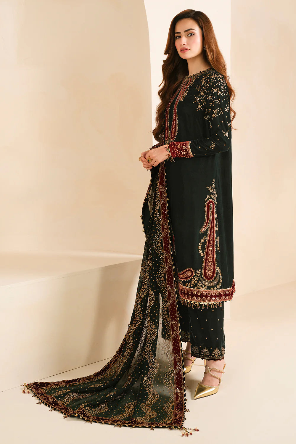 Front view of green embroidered velvet salwar kameez with georgette dupatta