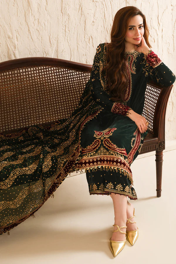 Model wearing green embroidered velvet salwar kameez with matching velvet trousers